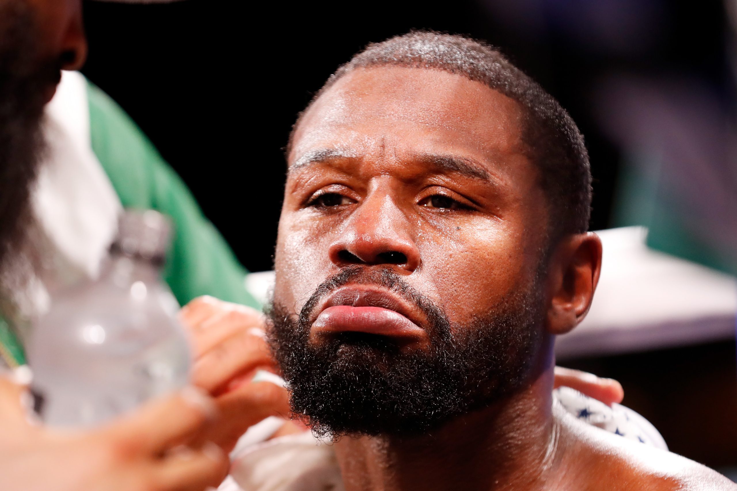 Floyd Mayweather receives attention in his corner during his contracted exhibition boxing match against Logan Paul.