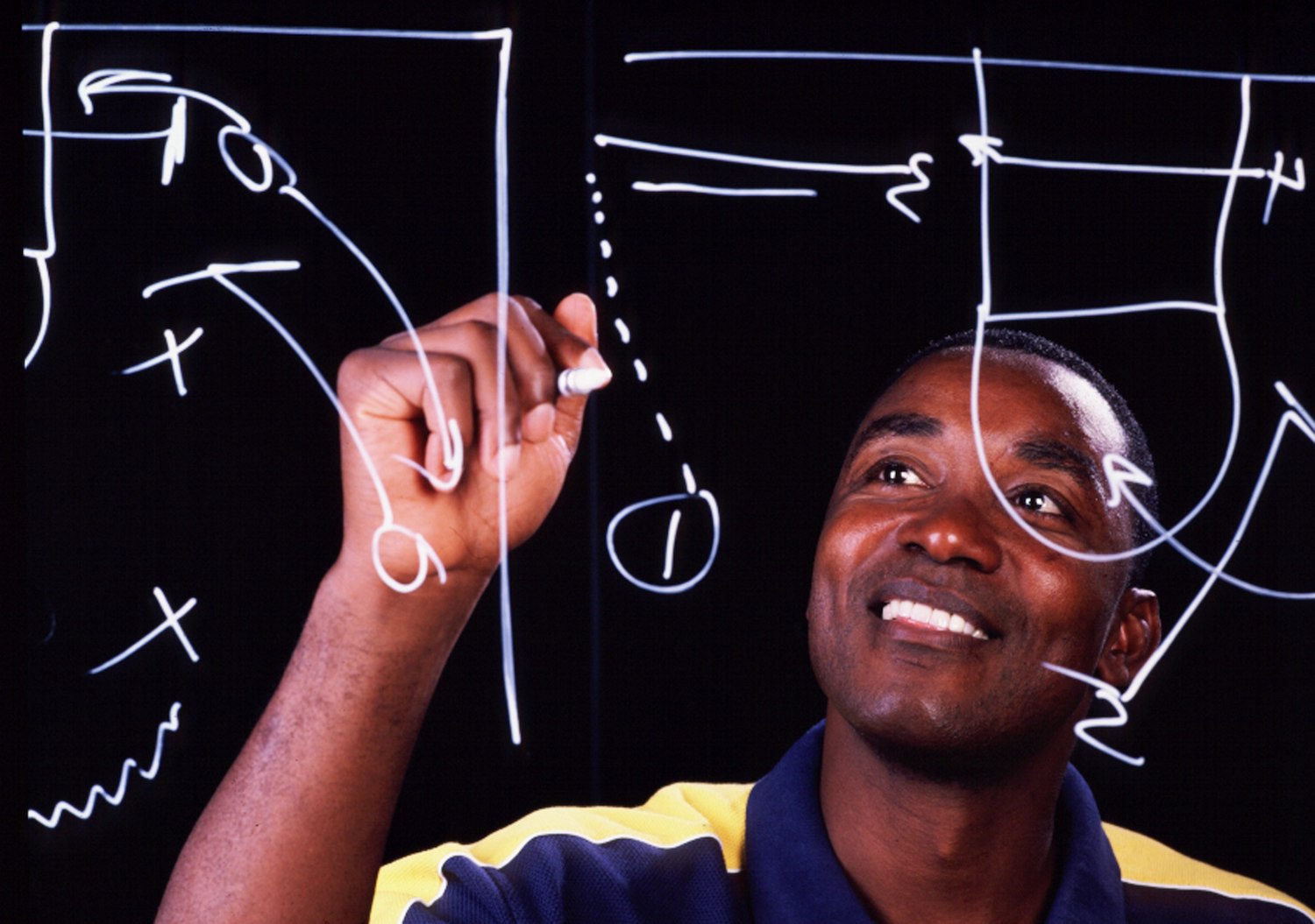 NBA legend Isiah Thomas draws up a play as the Indiana Pacers head coach.