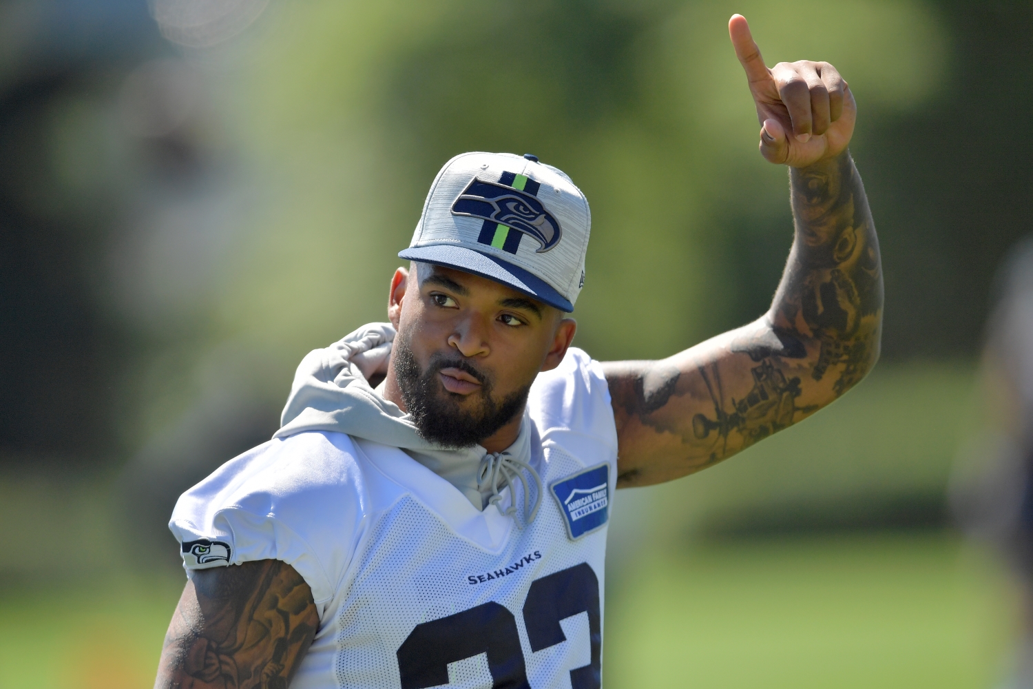 Seattle Seahawks safety Jamal Adams points in the air as he walks the field during training camp.