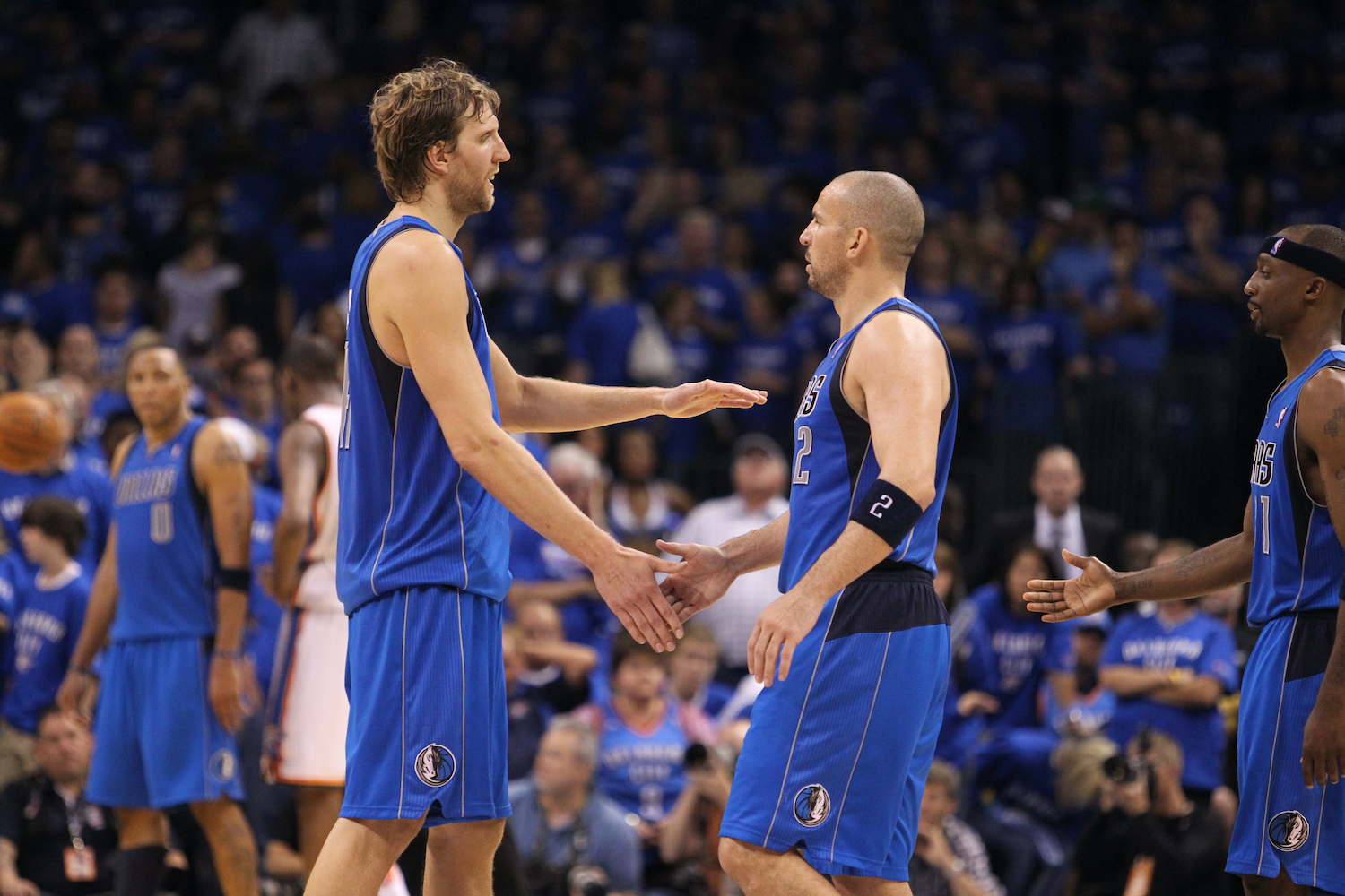 Dirk Nowitzki (L) congratulates Dallas Mavericks guard Jason Kidd (R).