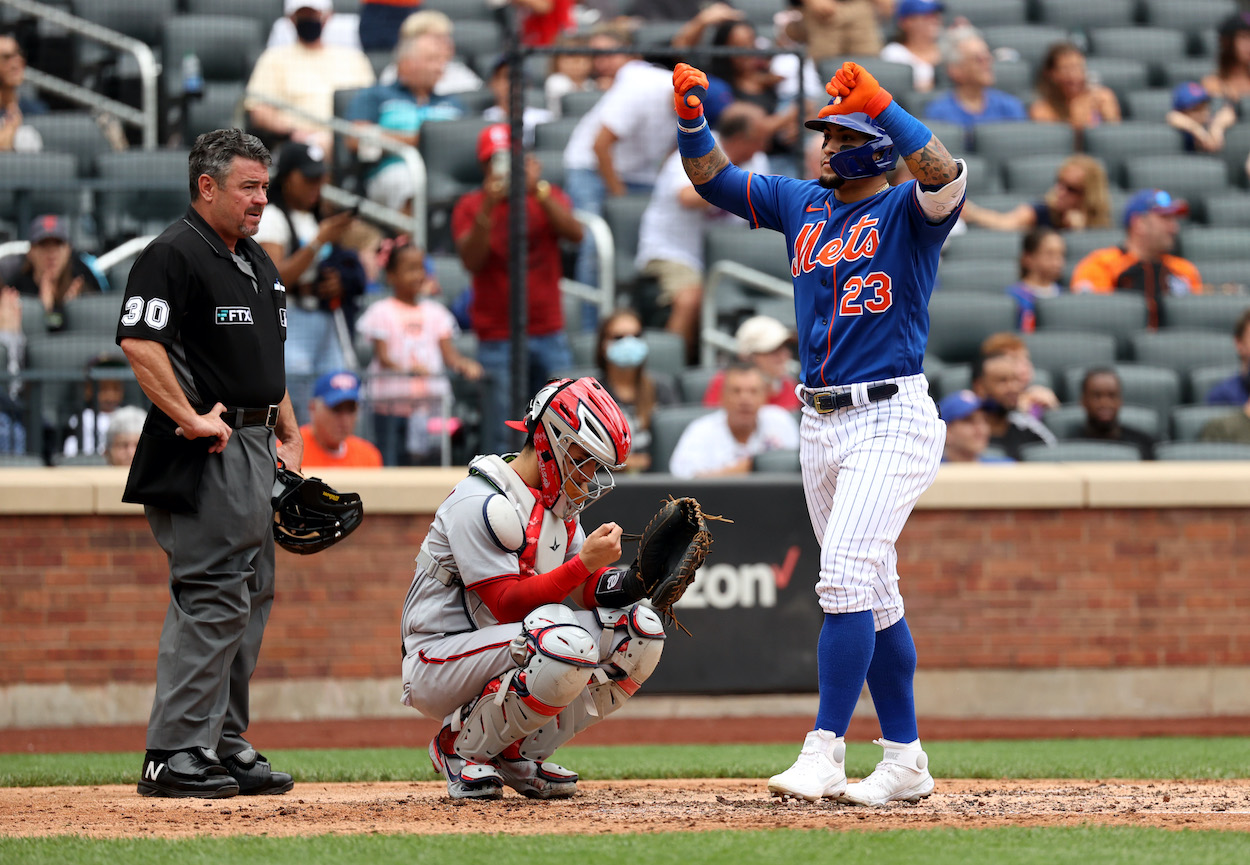 Javier Baez of the New York Mets, whol along with teammate Francisco Lindor are giving fans the thumbs down sign, reacts after hitting a two run home run during the bottom of the fourth inning of a game against the Washington Nationals at Citi Field on August 29, 2021 in New York City.