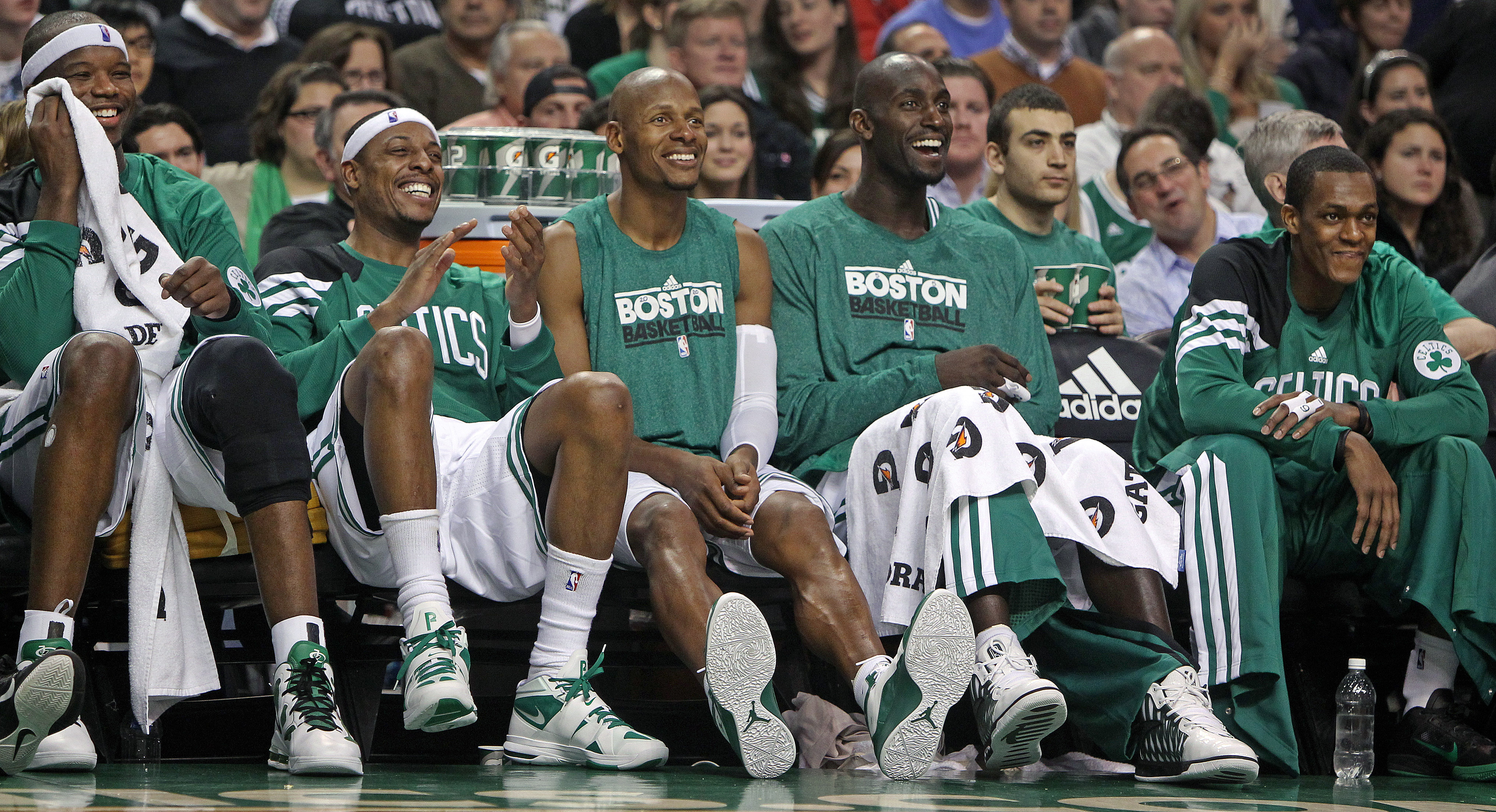 Jermaine O'Neal, Kevin Garnett, Ray Allen and others laugh sitting on Celtics bench