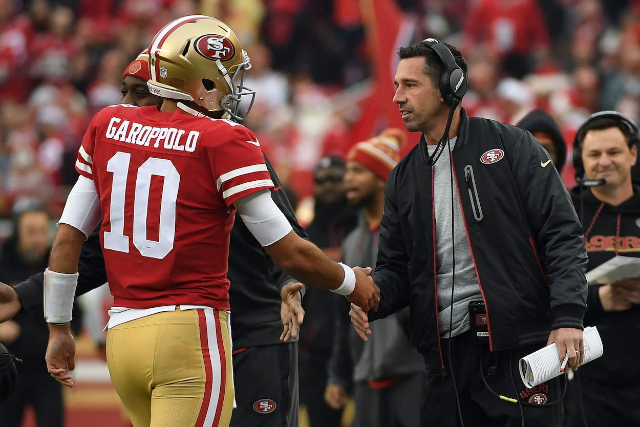 Head coach Kyle Shanahan of the San Francisco 49ers congratulates Jimmy Garoppolo after a one-yard touchdown run against the Jacksonville Jaguars during their NFL game at Levi's Stadium on December 24, 2017 in Santa Clara, California.