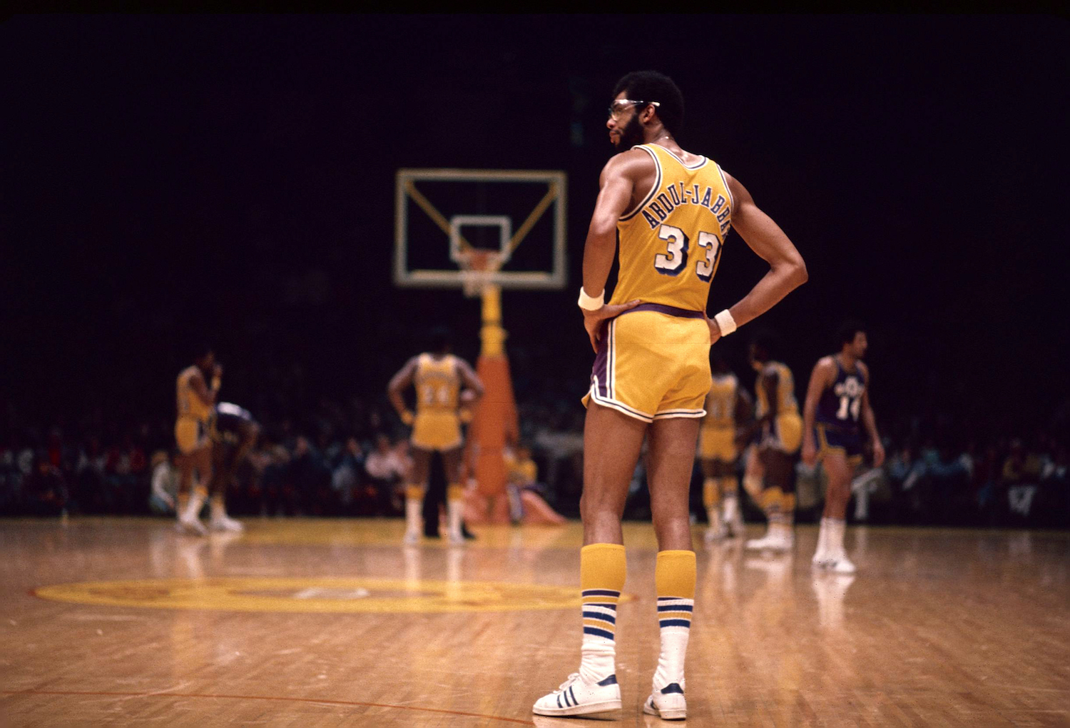 Kareem Abdul-Jabbar, who has a legitimate claim to the NBA GOAT title, stands on the court during a Los Angeles Lakers game.