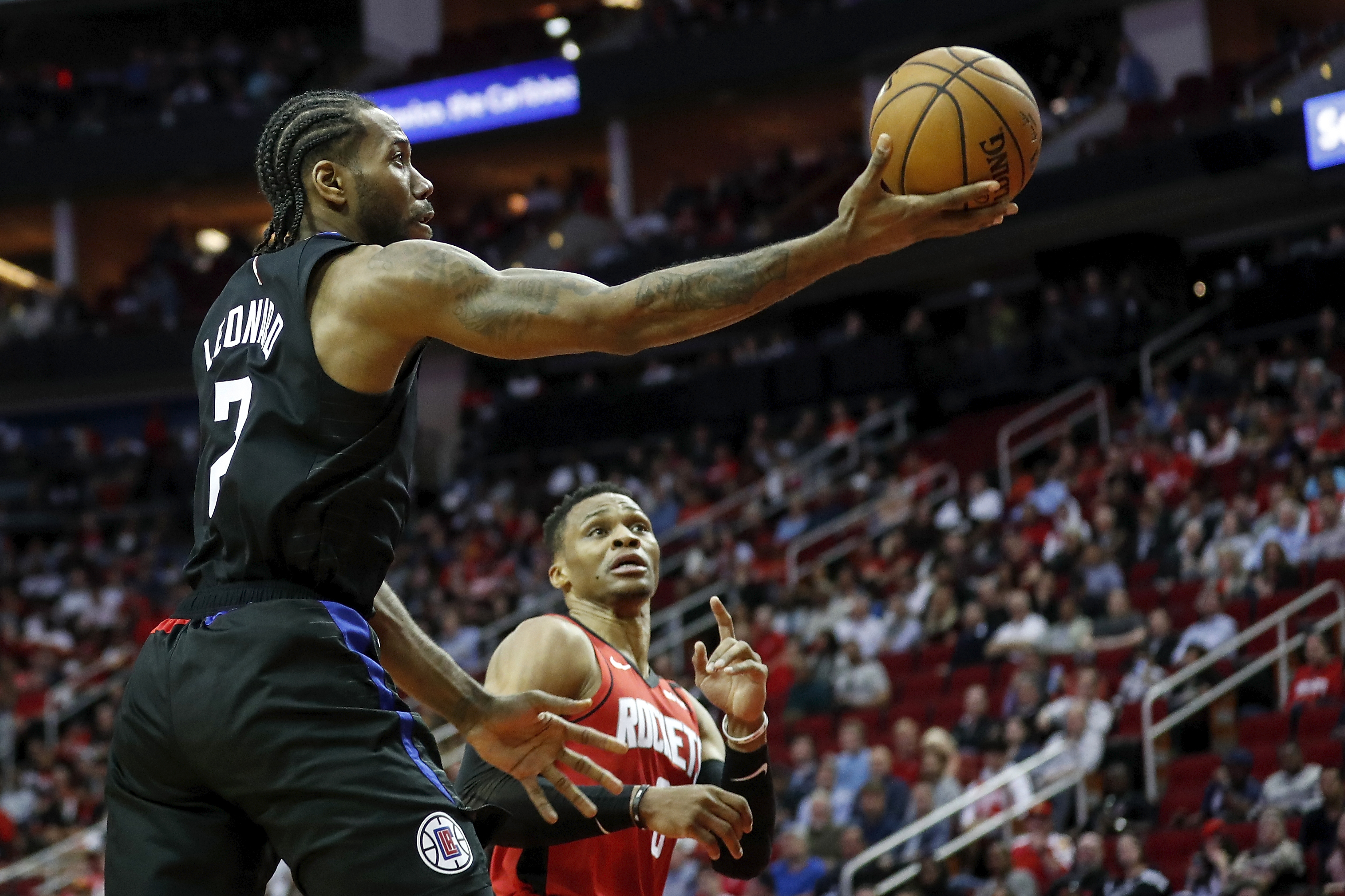 Kawhi Leonard drives past Russell Westbrook during the 2019-20 season