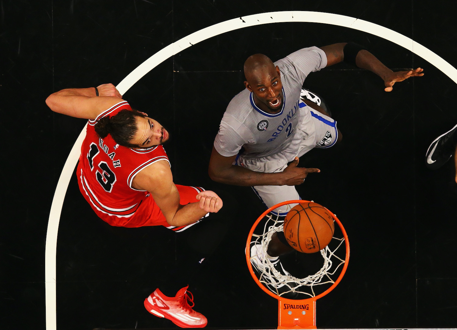 Joakim Noah of the Chicago Bulls and Kevin Garnett of the Brooklyn Nets position themselves for a rebound.
