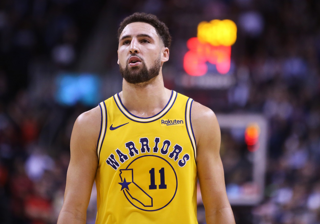 Warriors guard Klay Thompson reacts to a play during an NBA game.