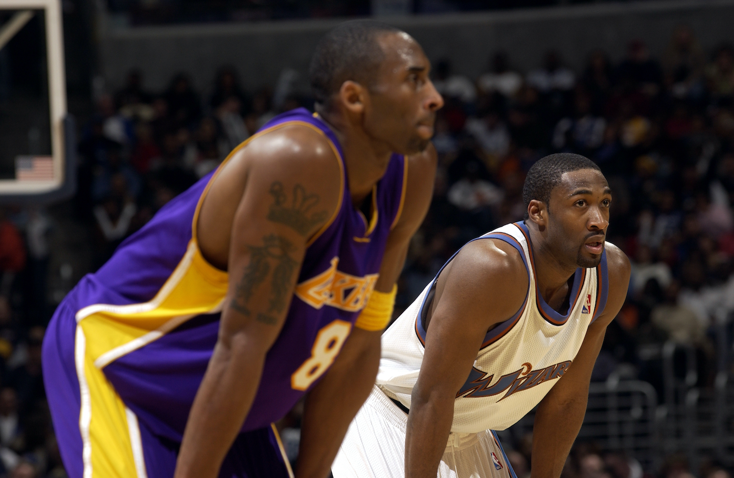 Kobe Bryant (L) and Gilbert Arenas (R) stand on the court during a 2005 NBA contest.