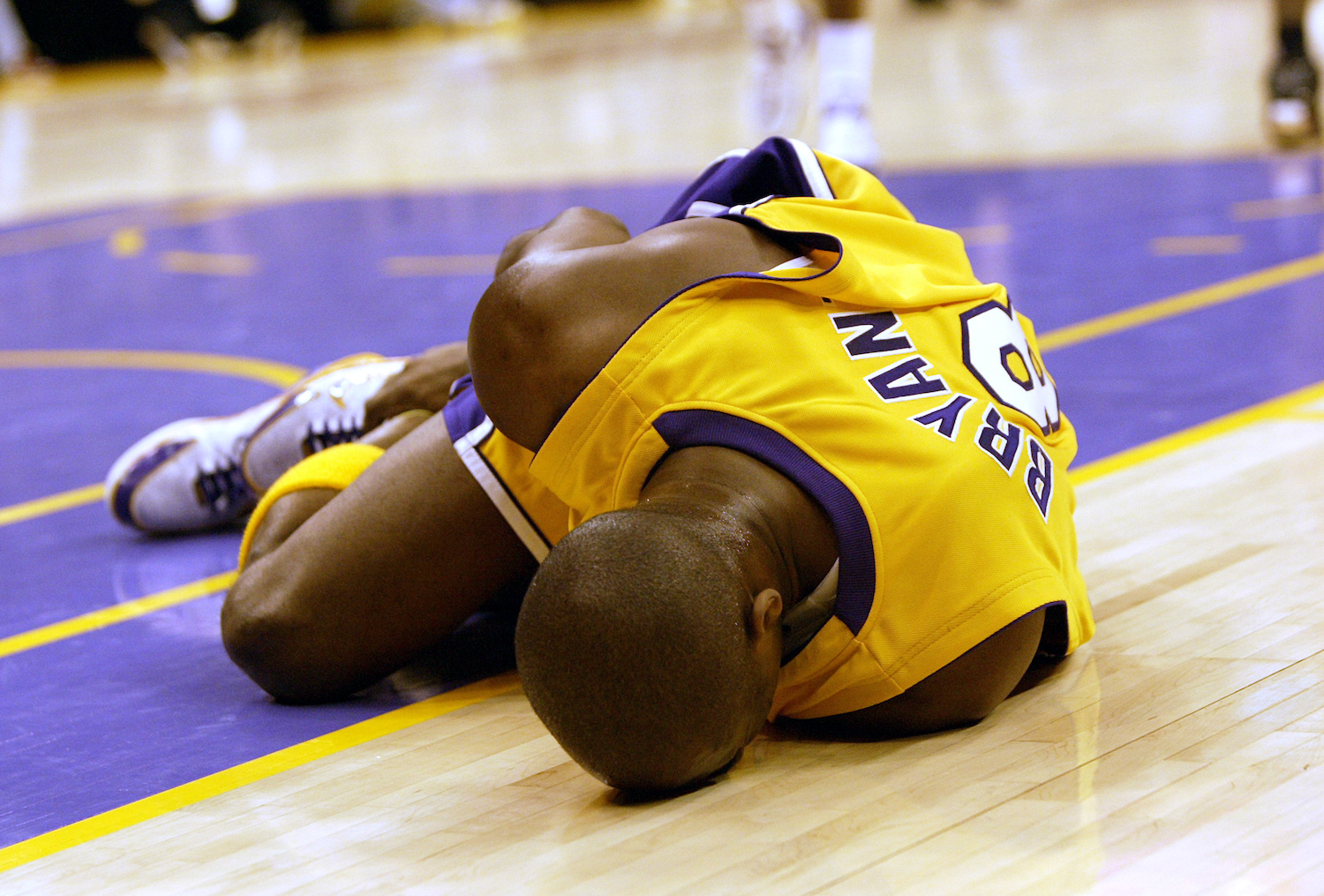 Lakers legend Kobe Bryant holds his ankle after a 2005 injury.