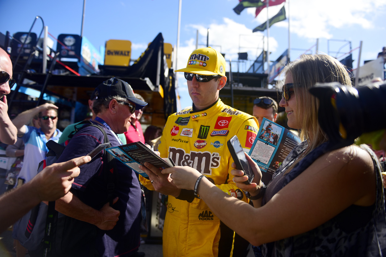 Kyle Busch signs autographs for fans