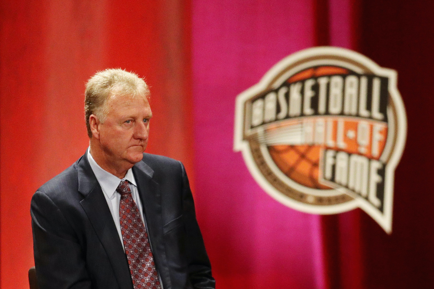 Boston Celtics legend Larry Bird looks on during a Basketball Hall of Fame enshrinement ceremony.