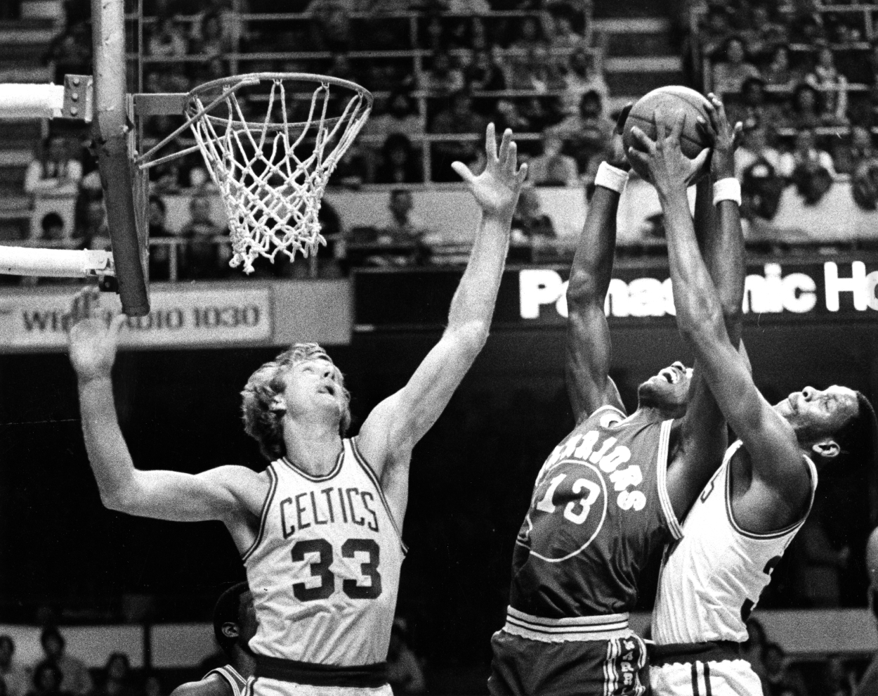 Boston Celtics' Larry Bird, left, and Cedric Maxwell, right, try to block a shot by the Warriors' Larry Smith.