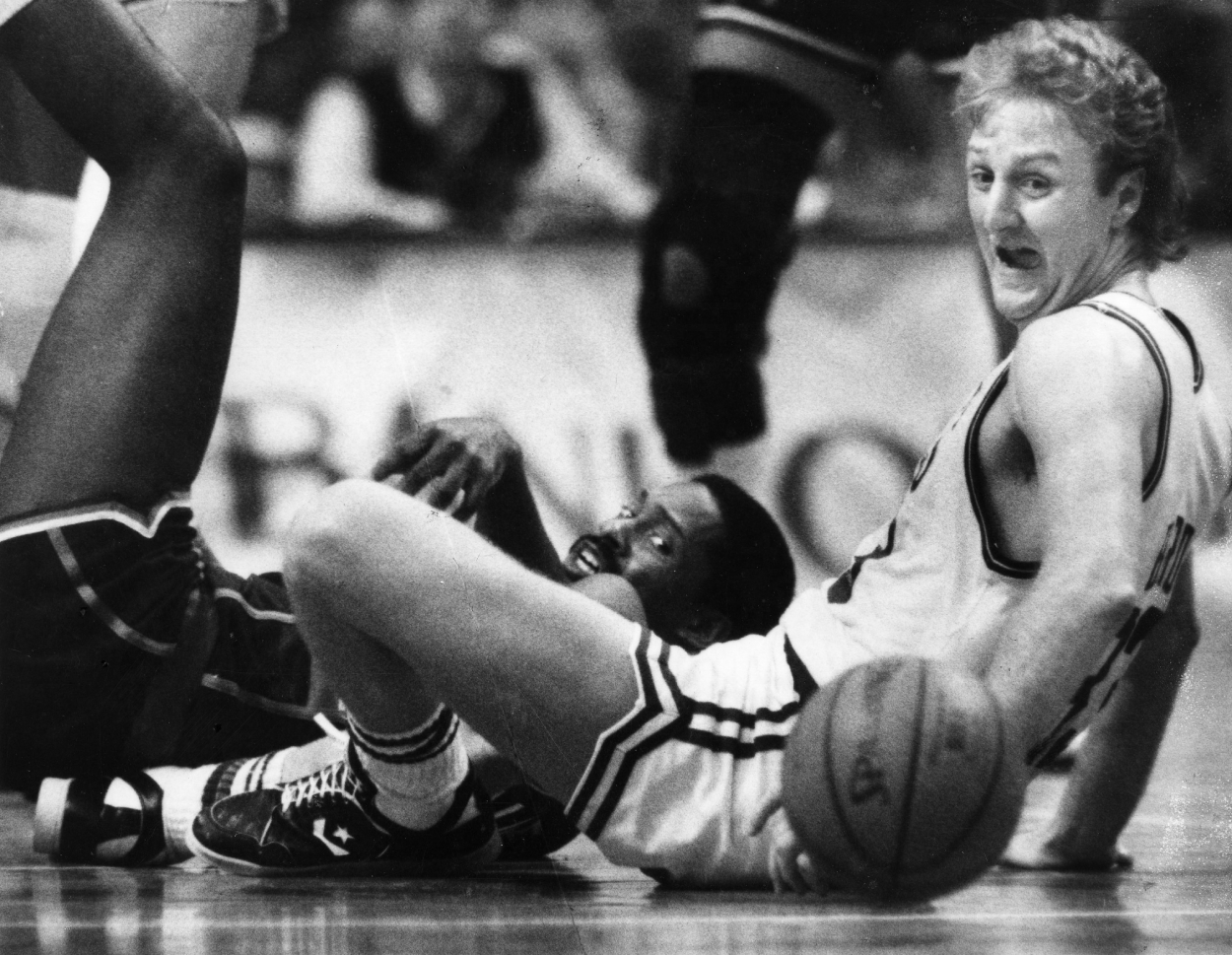 Boston Celtics' Larry Bird, front, reacts to a dropped ball along with Milwaukee Bucks' Junior Bridgeman in 1987.