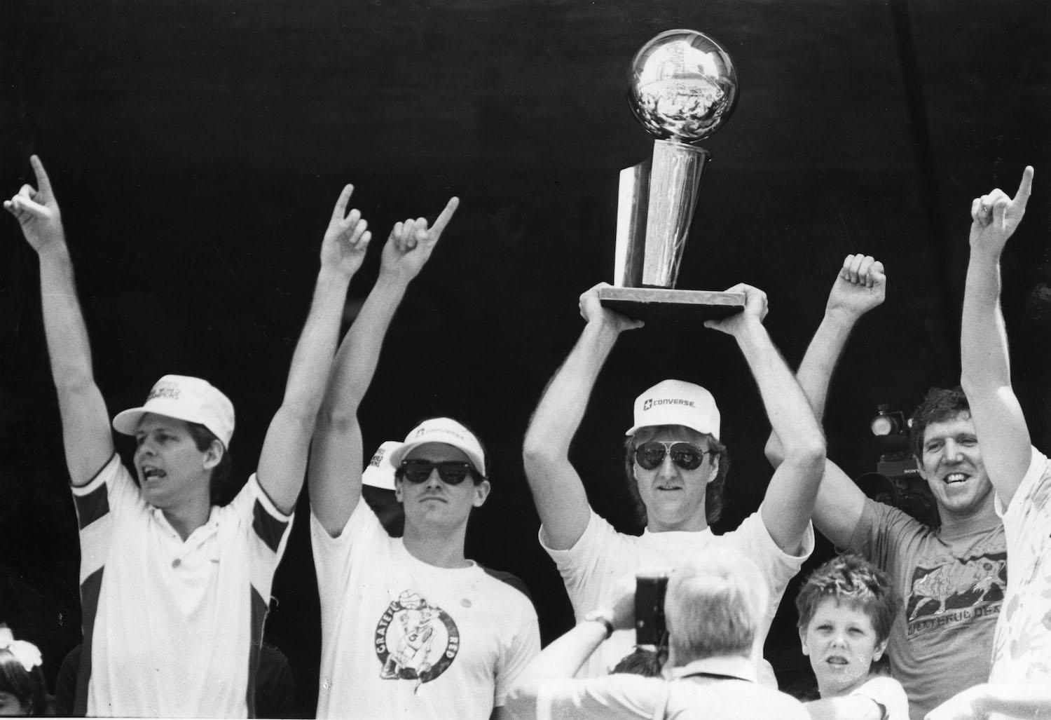 Larry Bird and his Boston Celtics teammates celebrate winning the NBA championship.