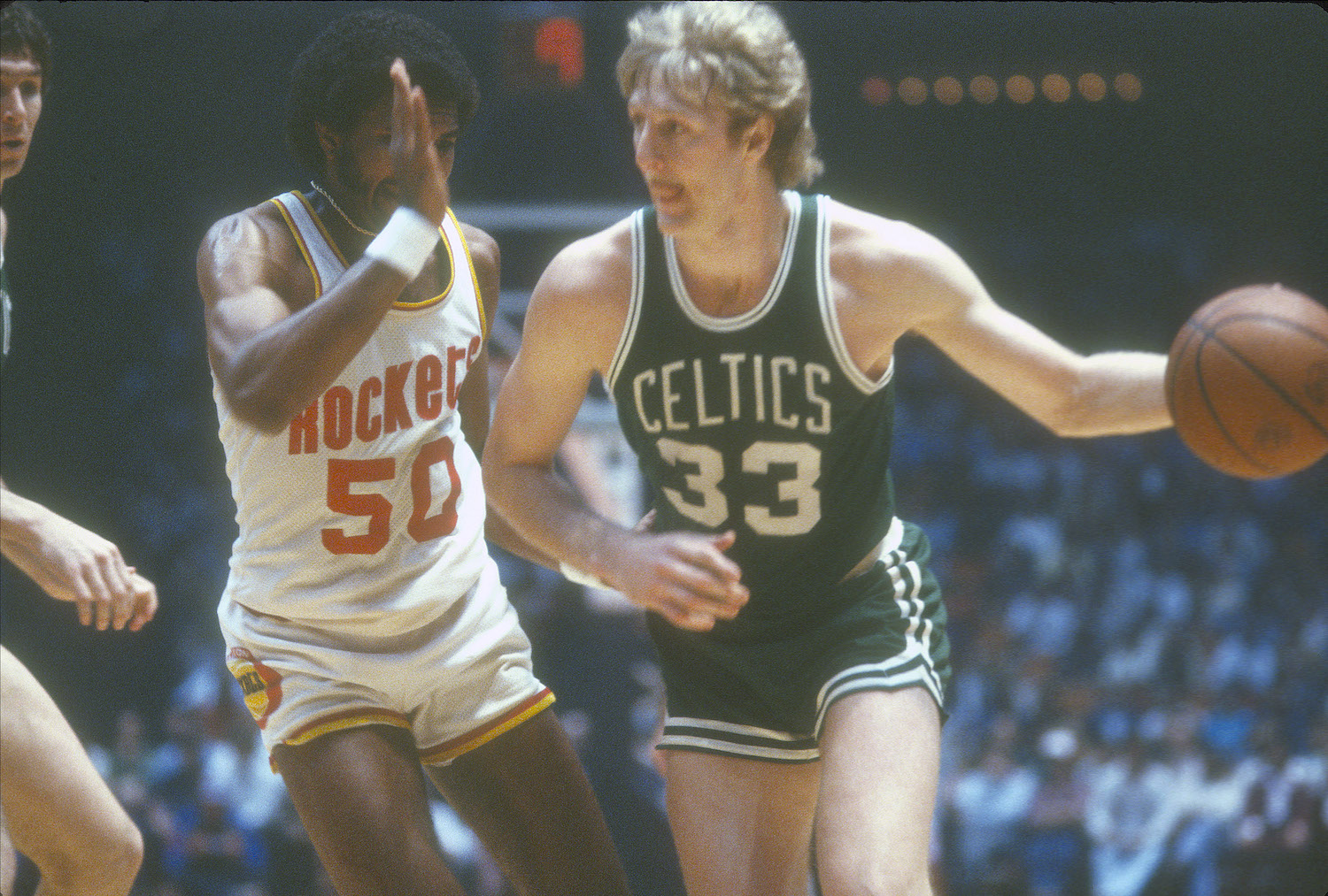 Boston Celtics forward Larry Bird dribbles the ball against the Houston Rockets.