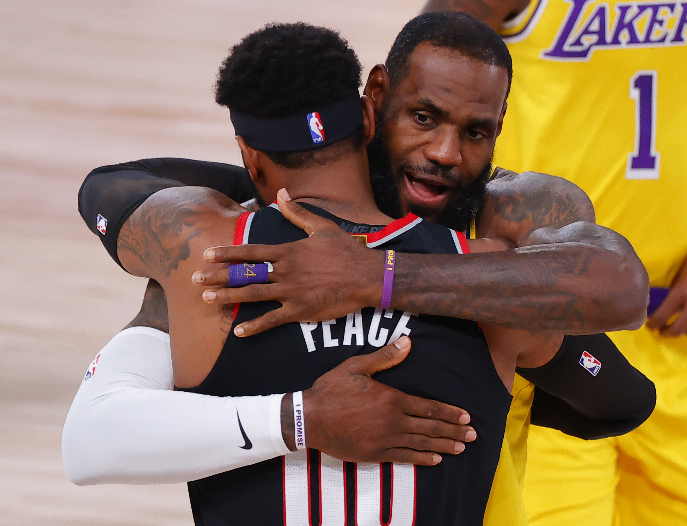 New Lakers teammates LeBron James and Carmelo Anthony embrace during a 2020 playoff game