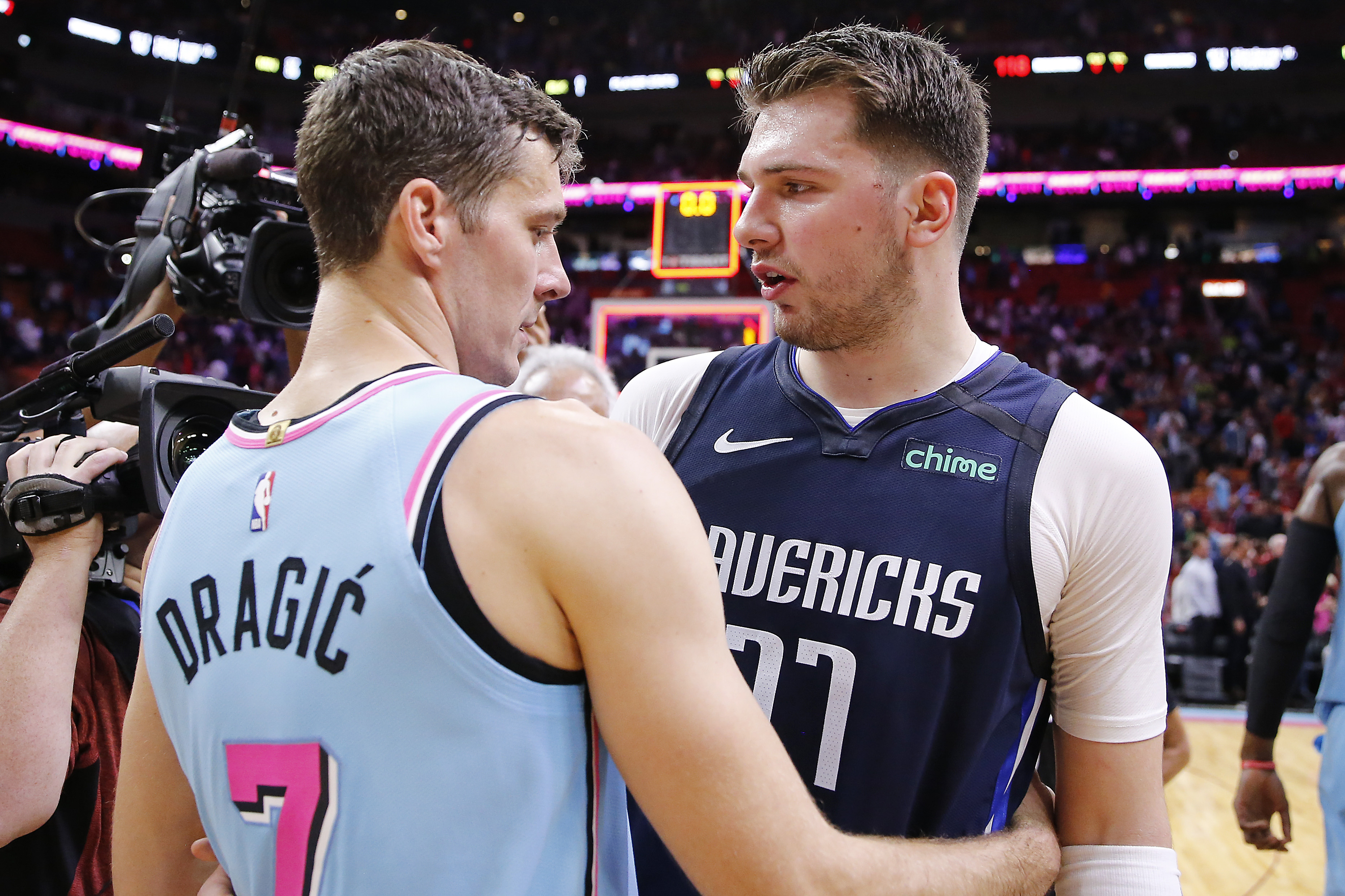 Luka Doncic and Goran Dragic embrace after the Dallas Mavericks played the Miami Heat last February
