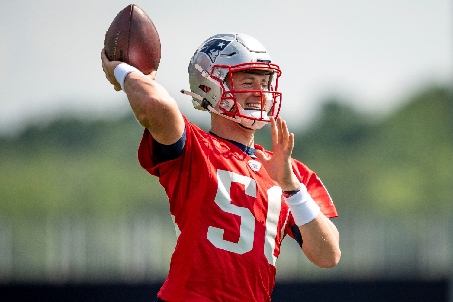 New England Patriots quarterback Mac Jones makes a throw during practice.