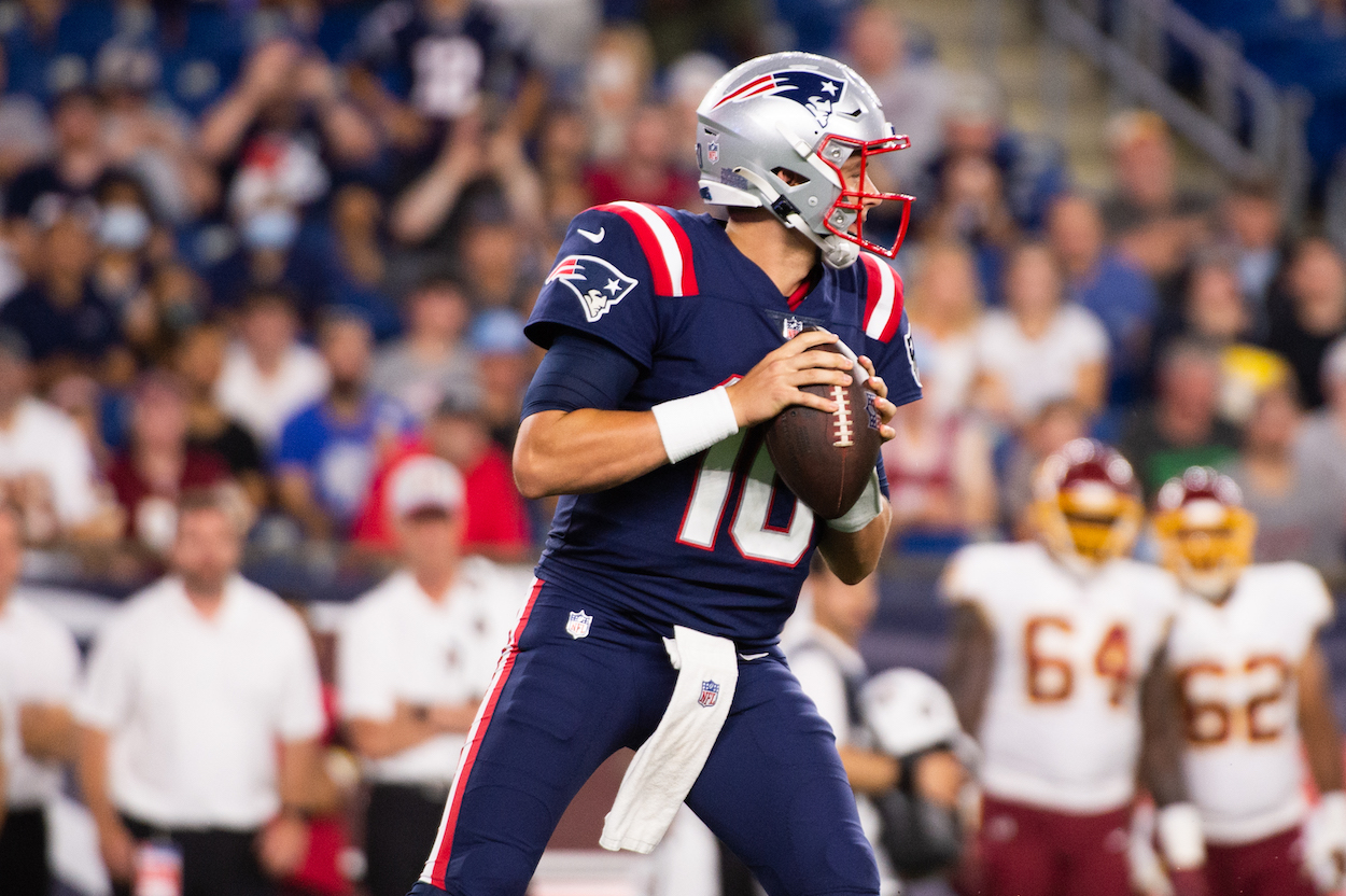 Mac Jones, No.10 of the New England Patriots looks to pass in the first half against the Washington Football Team at Gillette Stadium on August 12, 2021 in Foxborough, Massachusetts.