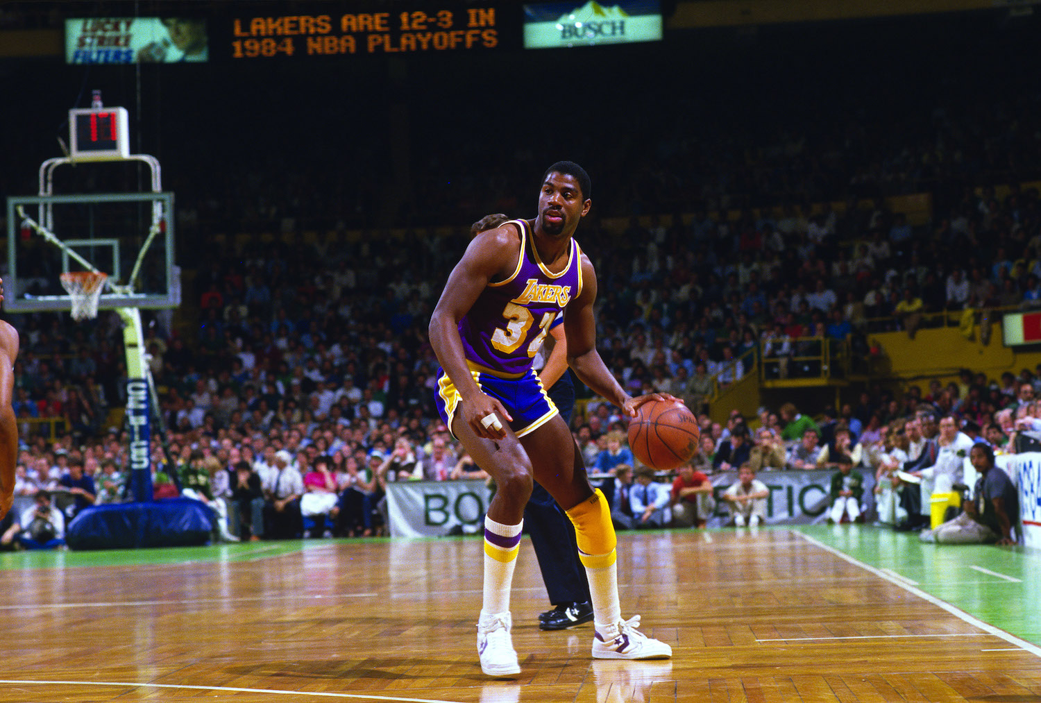 Lakers guard Magic Johnson dribbles the ball up the court during the 1984 NBA Finals.