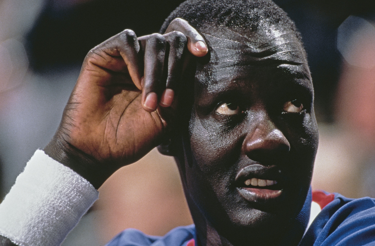 NBA center Manute Bol looks up at the scoreboard during a game in 1986