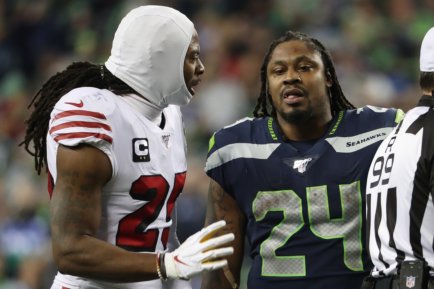 Richard Sherman of the San Francisco 49ers and Marshawn Lynch of the Seattle Seahawks talk during their game at CenturyLink Field on Dec. 29, 2019, in Seattle,.