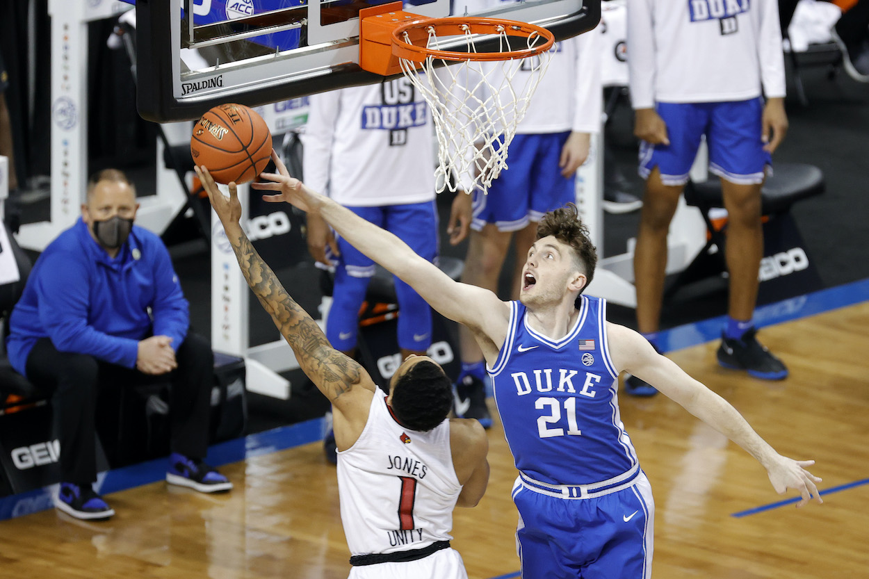 Houston Rockets undrafted free agent Matthew Hurt of the Duke Blue Devils attempts to block Carlik Jones of the Louisville Cardinals during the first half of their second round game in the ACC Men's Basketball Tournament at Greensboro Coliseum on March 10, 2021 in Greensboro, North Carolina.