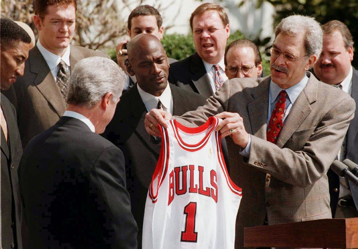 The Bulls team, including Michael Jordan, Luc Longley, and Phil Jackson, meeting with Bill Clinton at the White House