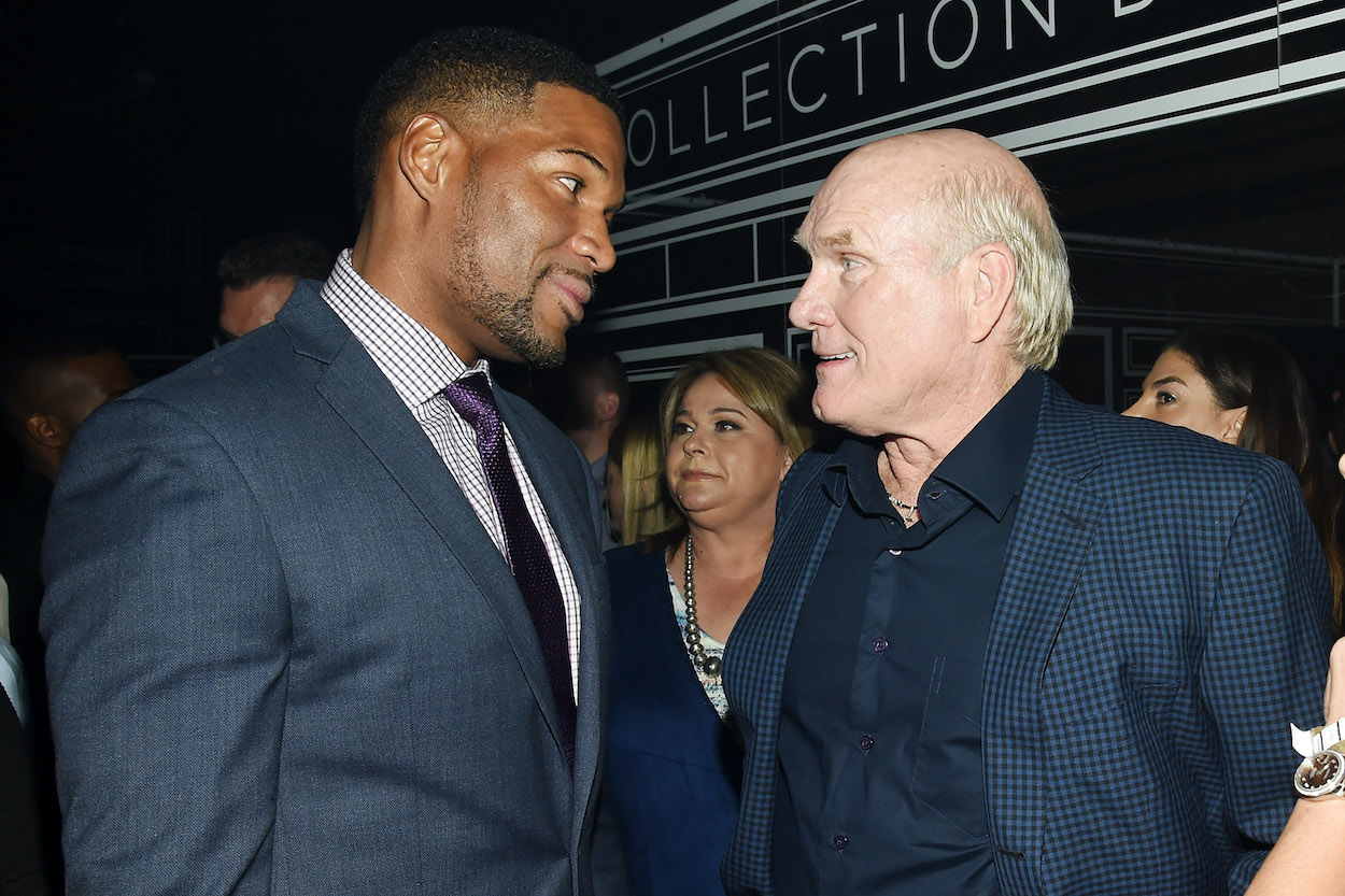 Michael Strahan and Terry Bradshaw talk to each other at function.
