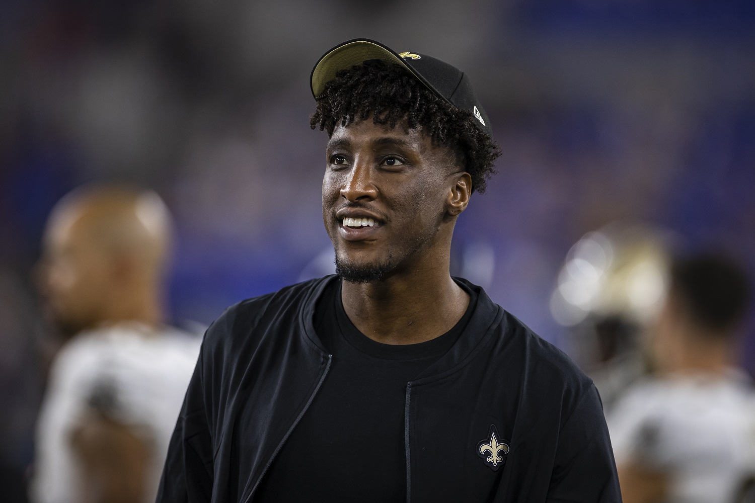 Michael Thomas of the New Orleans Saints looks on from the sidelines during the preseason game against the Baltimore Ravens at M&T Bank Stadium on Aug. 14, 2021.