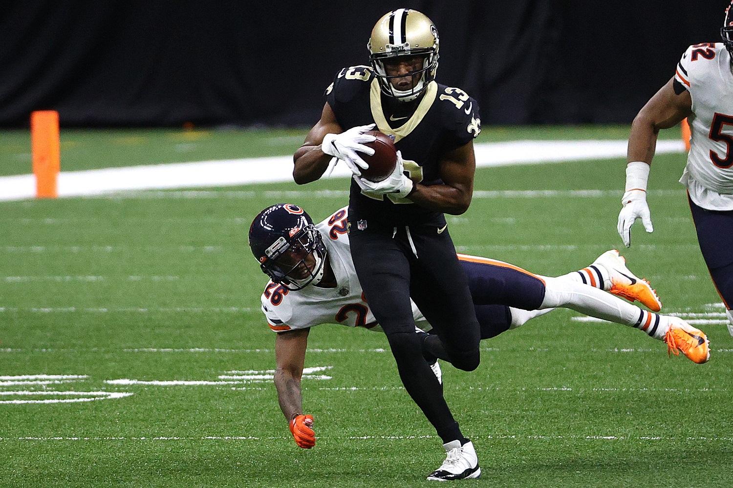 Michael Thomas of the New Orleans Saints runs through a tackle during the first quarter in the NFC playoffs against the Chicago Bears.