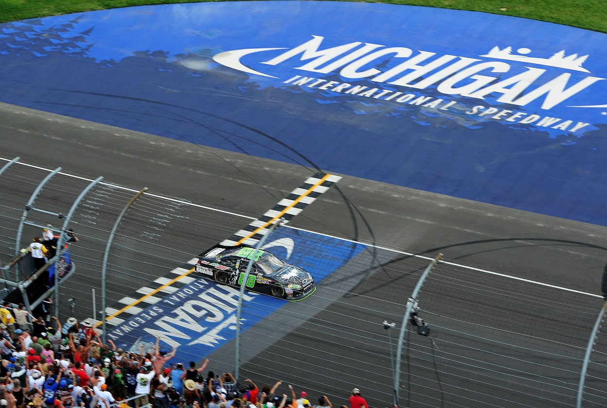 Dale Earnhardt Jr. crosses the finish line at Michigan International Speedway to win the 2014 NASCAR Cup Series Quicken Loans 400