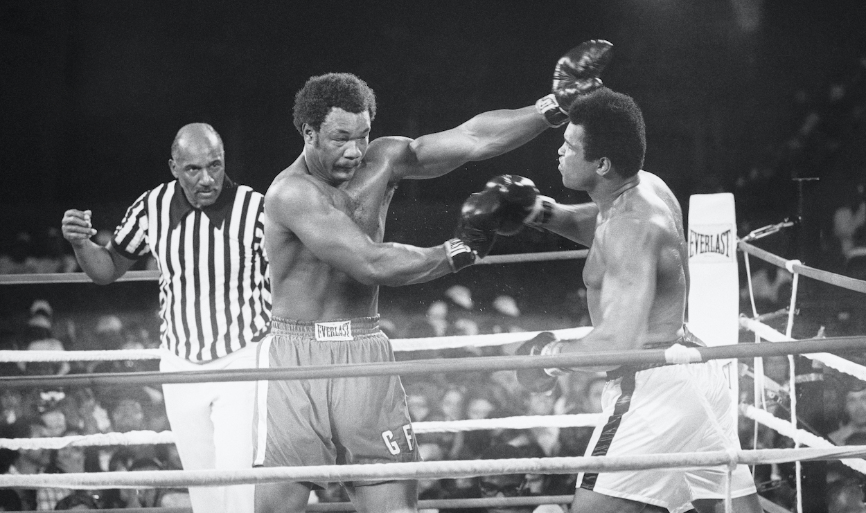 Heavyweight champ George Foreman (L), throws a left to the eye of the Muhammad Ali during their title bout, this shot twisted Ali's face but not his direction. He went on to regain his title by a kayo in the 8th round.