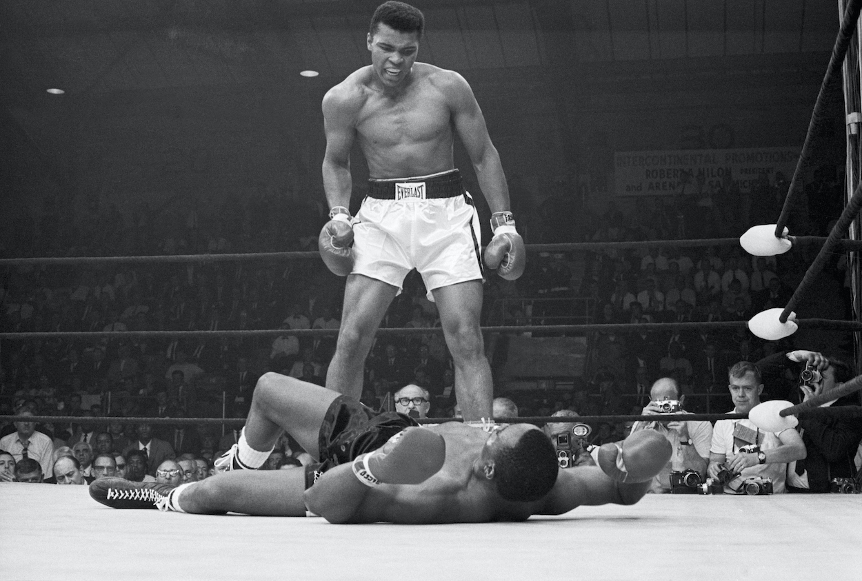 Heavyweight champion Muhammad Ali stands over Sonny Liston and taunts him to get up during their title fight. Ali knocked Liston out in one minute in the first round during their bout at the Central Maine Youth Center in Lewiston, Maine.