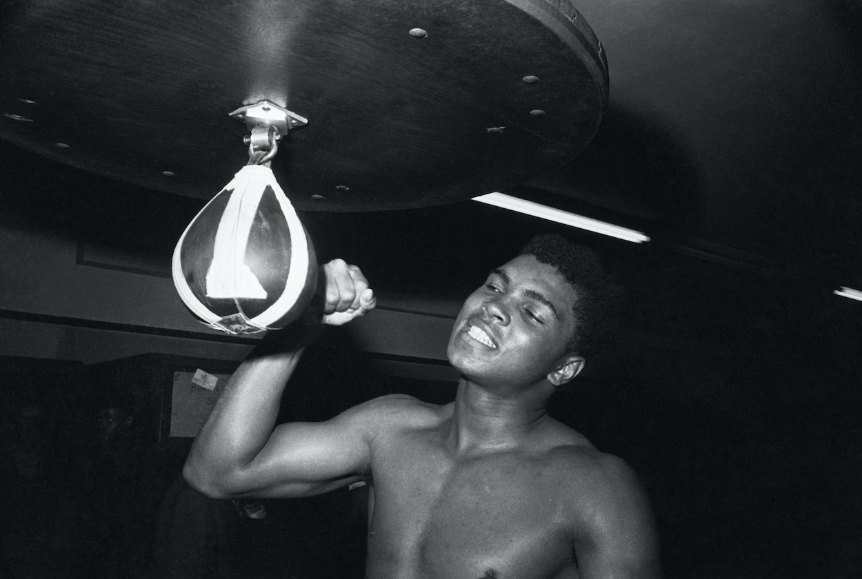A young Cassius Clay (Muhammad Ali) punching a speed bag.