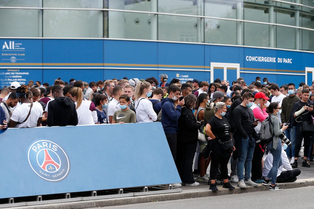 People gather outside the Parc des Princes stadium in Paris as Argentinian football player Lionel Messi is expected to arrive on August 9, 2021, a day after the 34-year-old told at his tearful farewell news conference in Barcelona that joining French football club Paris Saint-Germain was a "possibility."