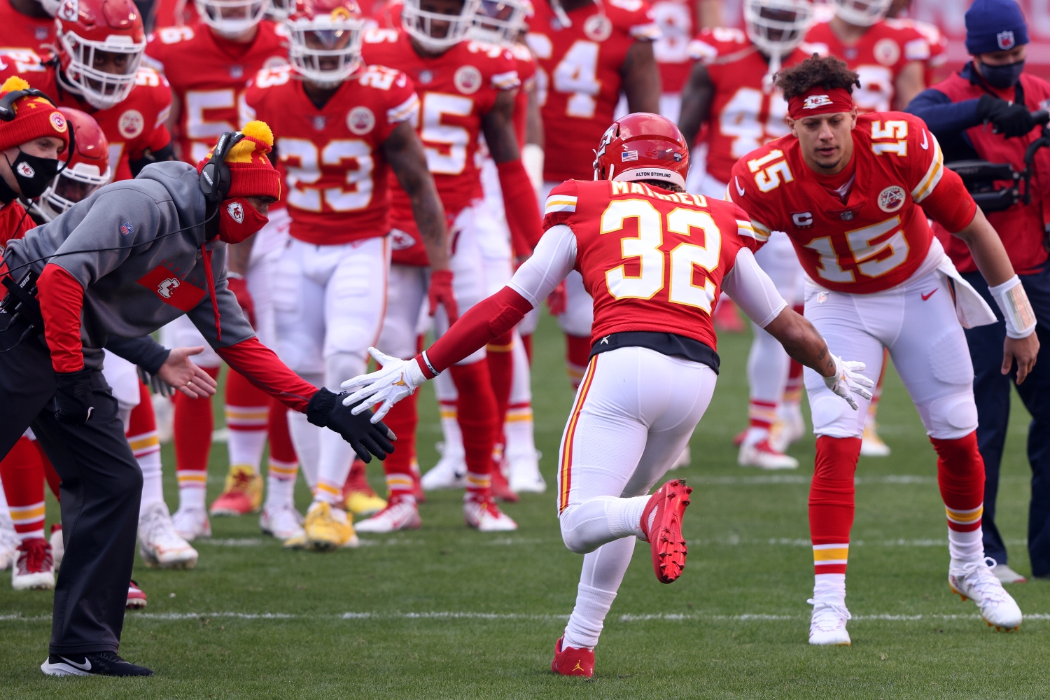 Kansas City Chiefs quarterback Patrick Mahomes greets safety Tyrann Mathieu as he jogs onto the field.