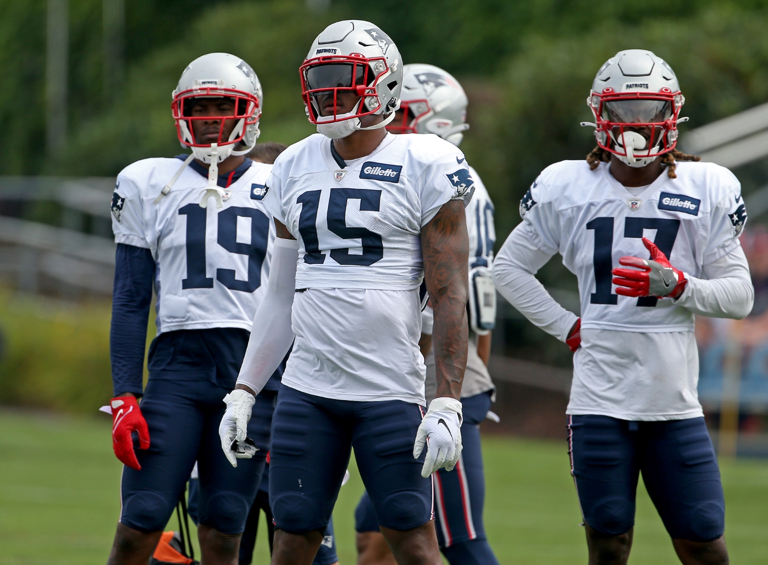 New England Patriots receivers Isaiah Zuber (19), N'Keal Harry (15), and Kristian Wilkerson (17) stand together during training camp practice.