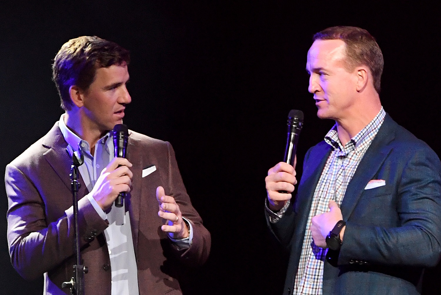 Eli Manning and Peyton Manning speak during the EA Sports Bowl on Jan. 30, 2020, in Miami.