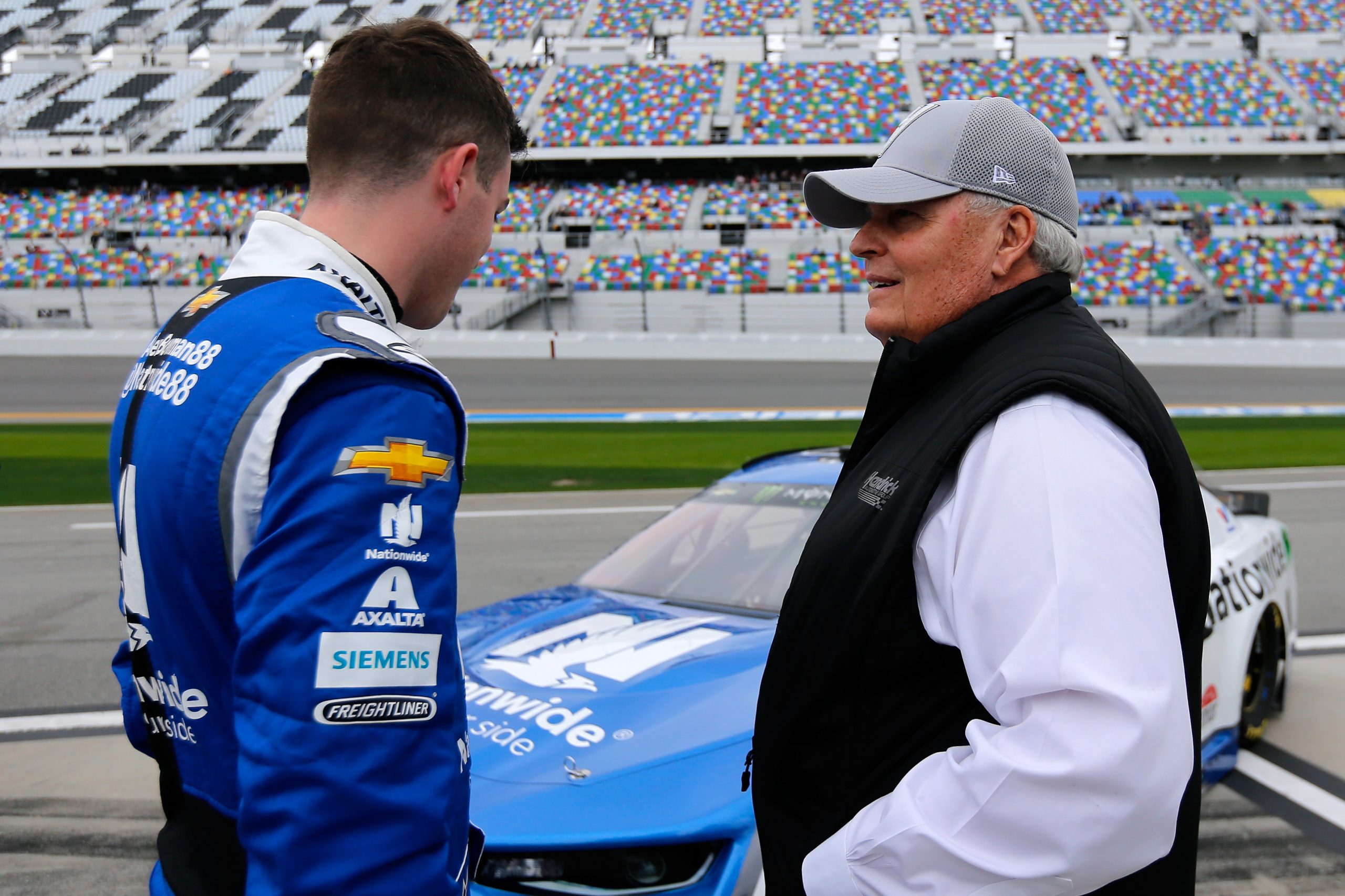 Alex Bowman, driver of the #88 Nationwide Chevrolet, talks with team owner Rick Hendrick.