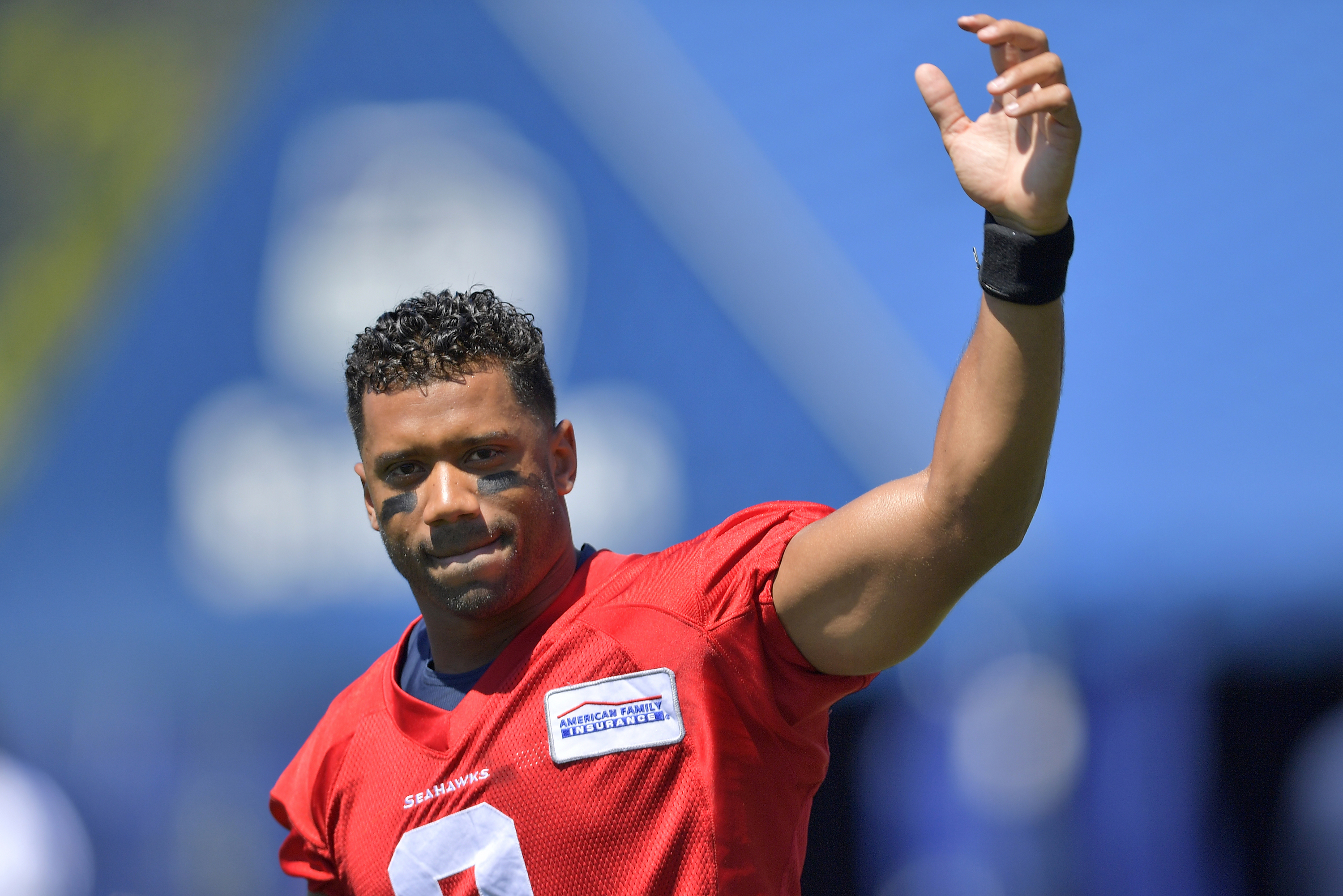 Russell Wilson waves to the crowd during Seattle Seahawks training camp