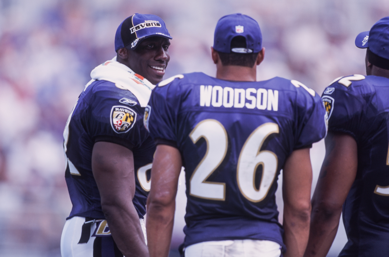 Shannon Sharpe of the Baltimore Ravens chats with team mates Rod Woodson and Ray Lewis during a pre season game against New York Giants on August 31st, 2001 in Baltimore, Maryland,USA.