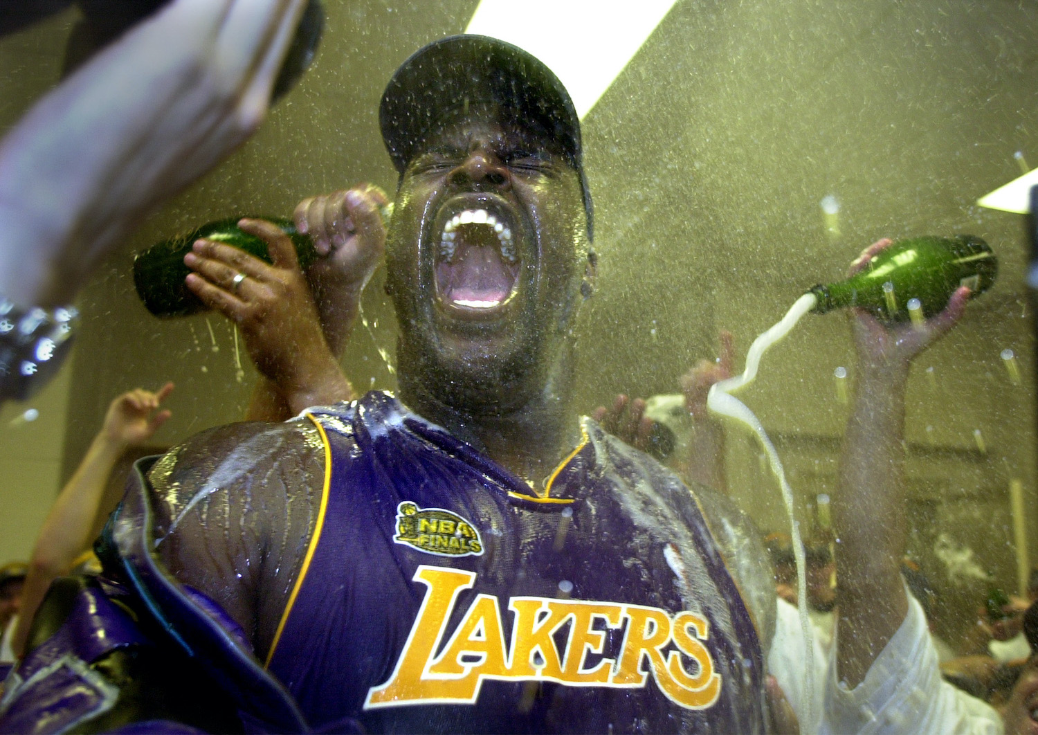 Los Angeles Lakers big man Shaquille O'Neal is doused in champagne after winning the 2001 NBA championship.