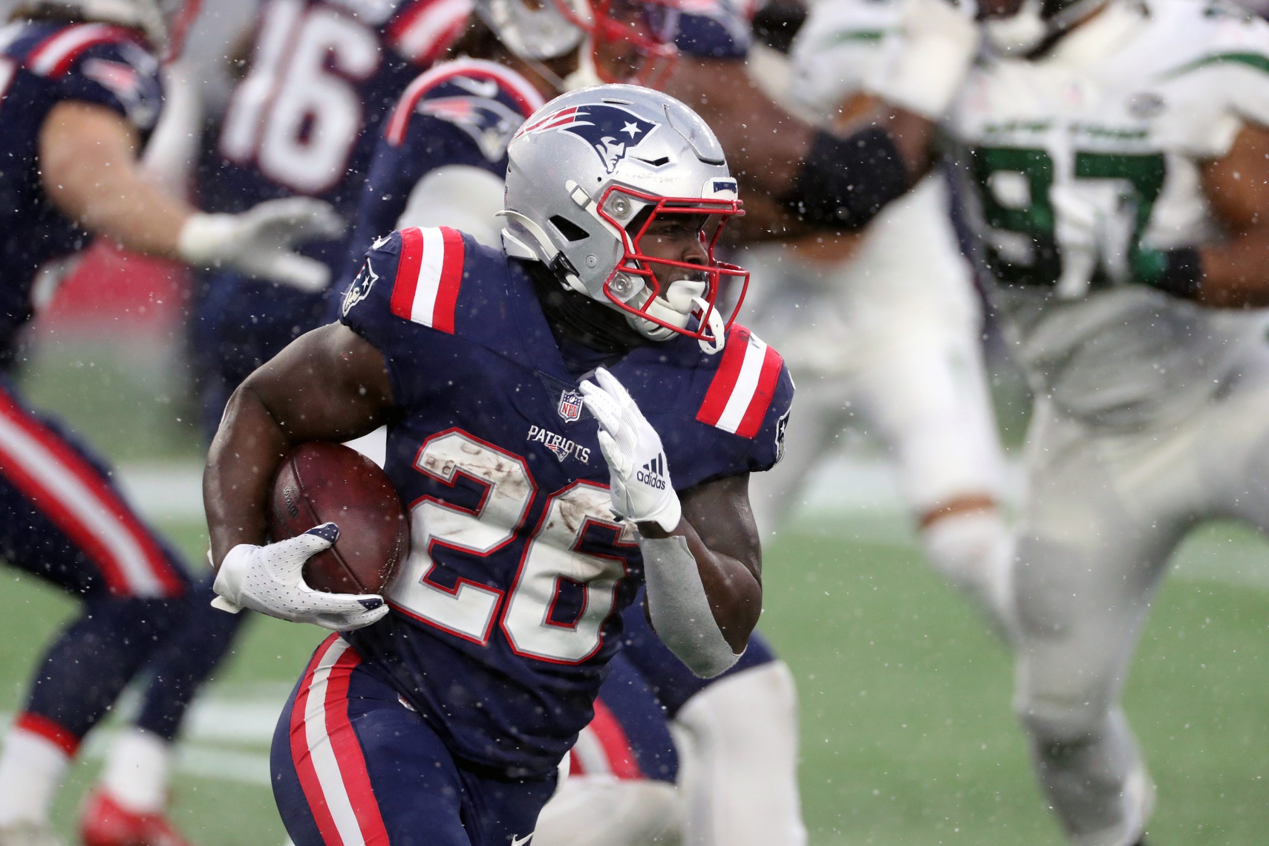 Sony Michel of the New England Patriots has a long gain in the snow against the New York Jets.