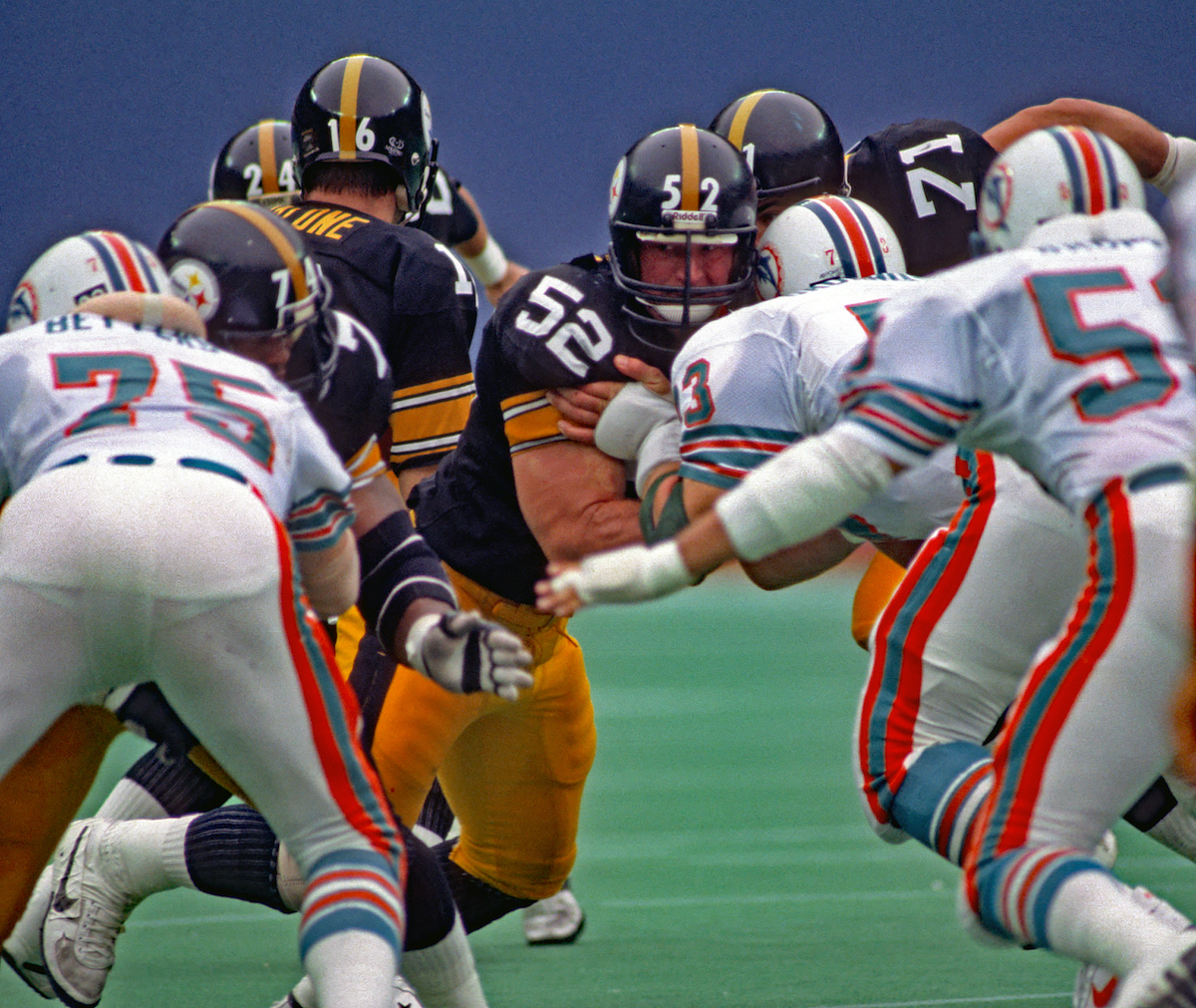 Center Mike Webster of the Pittsburgh Steelers, one of the best NFL centers of all time, blocks Miami Dolphins defensive linemen