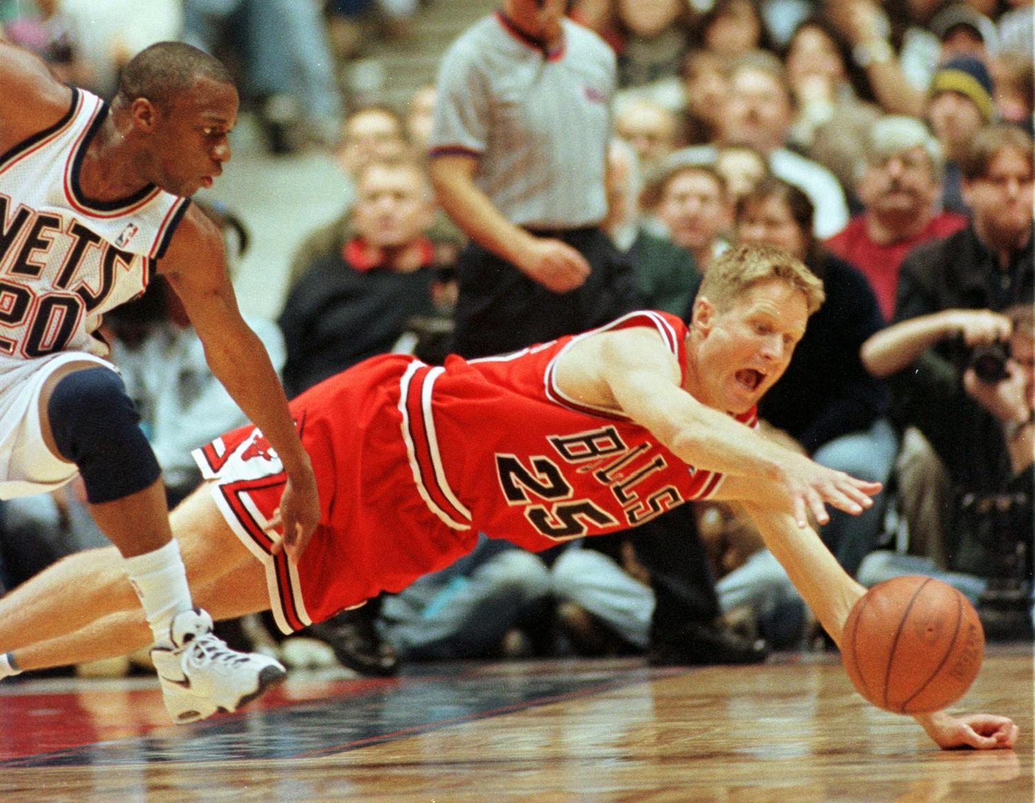 Chicago Bulls guard Steve Kerr dives to corral a loose ball.
