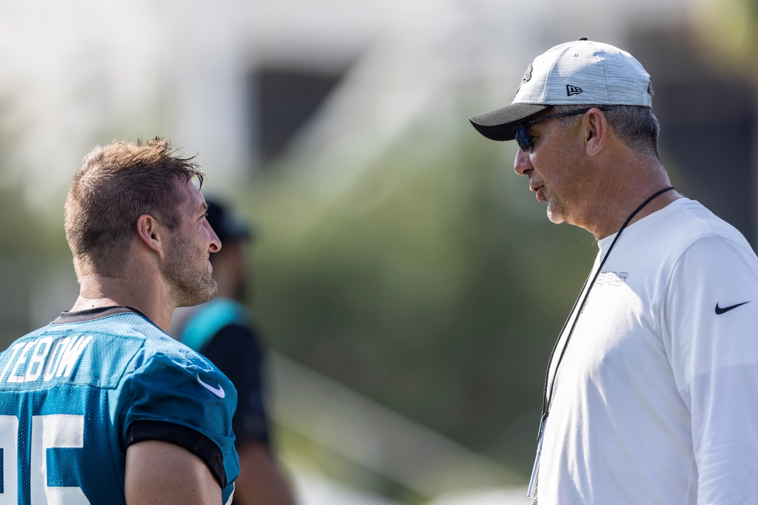 Jacksonville Jaguars tight end Tim Tebow speaks with head coach Urban Meyer.