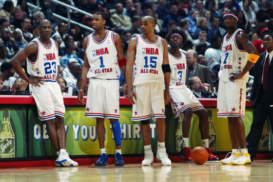 Michael Jordan and Vince Carter stand together as members of the 2003 NBA Eastern Conference All-Star team.