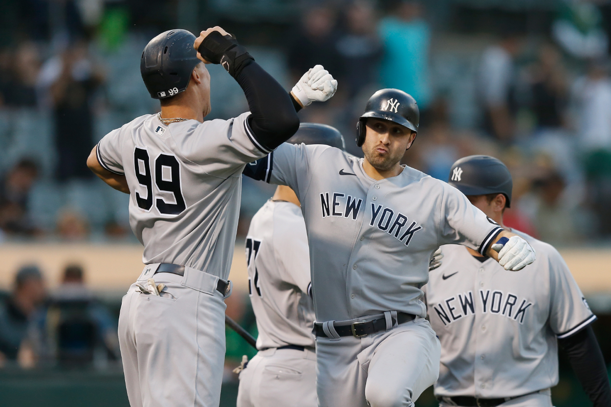 Joey Gallo of the New York Yankees celebrates with Aaron Judge #99 after hitting a three-run home run.