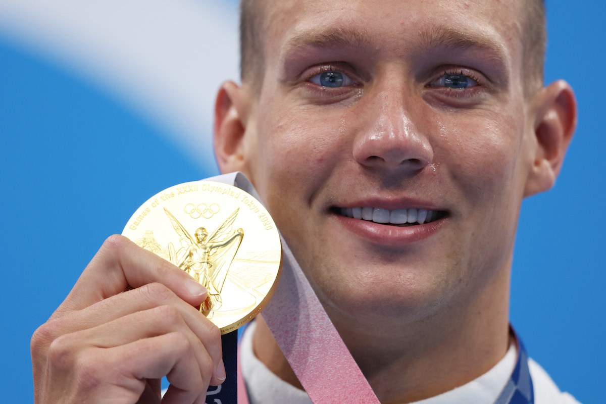 Caeleb Dressel holds and Olympic gold medal in swimming